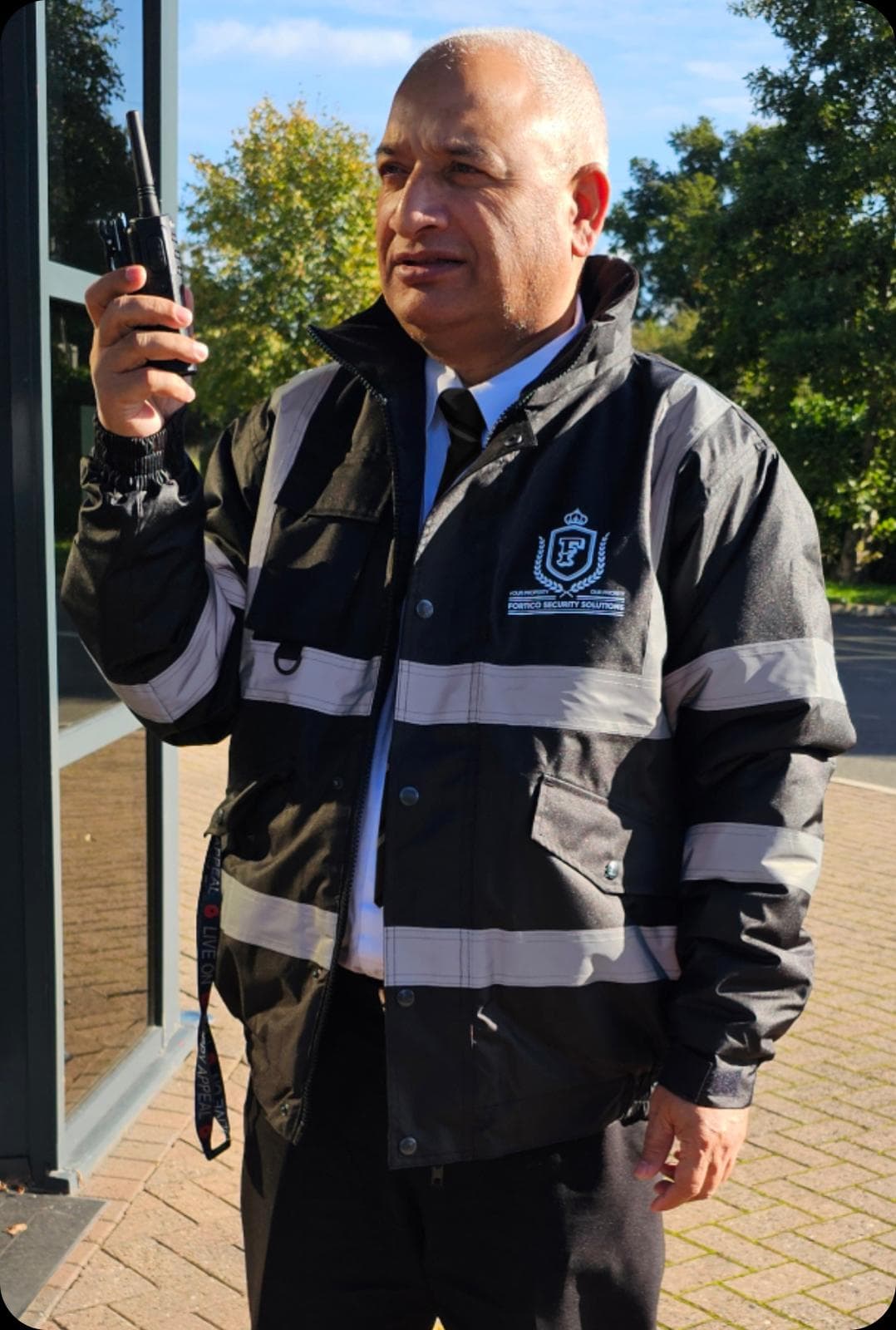 Professional security guard with radio on manned guarding duty UK